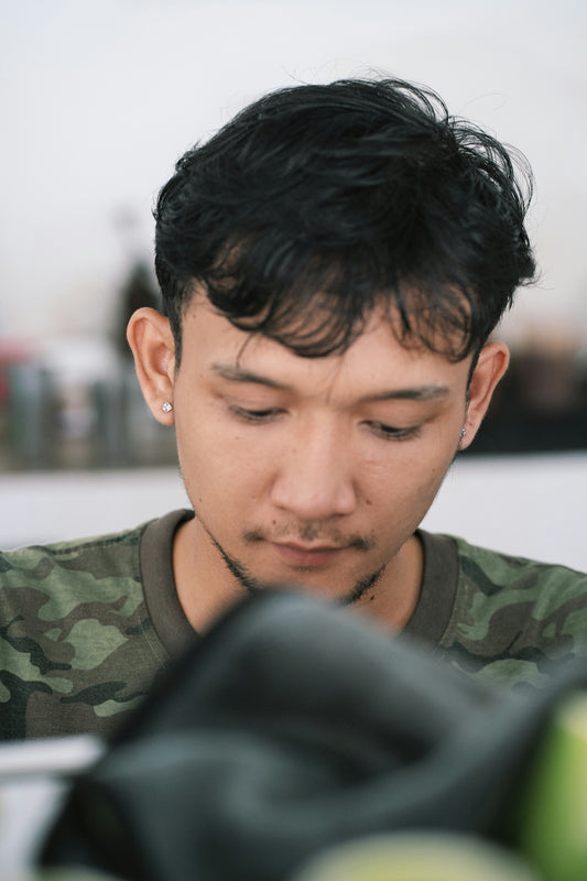 a man looking down at a cell phone