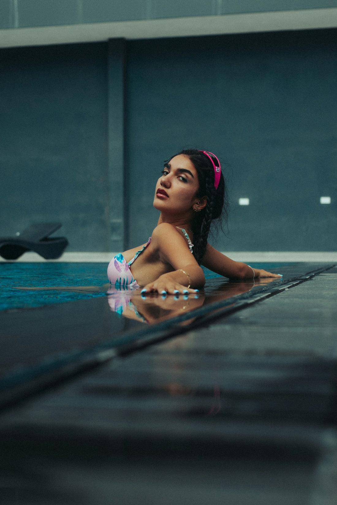 A woman laying on the ground in a swimming pool