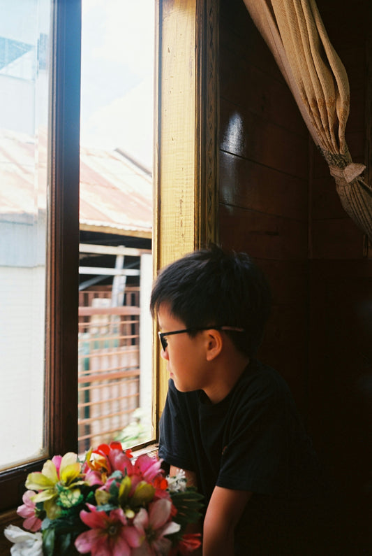 A boy looks out a window.